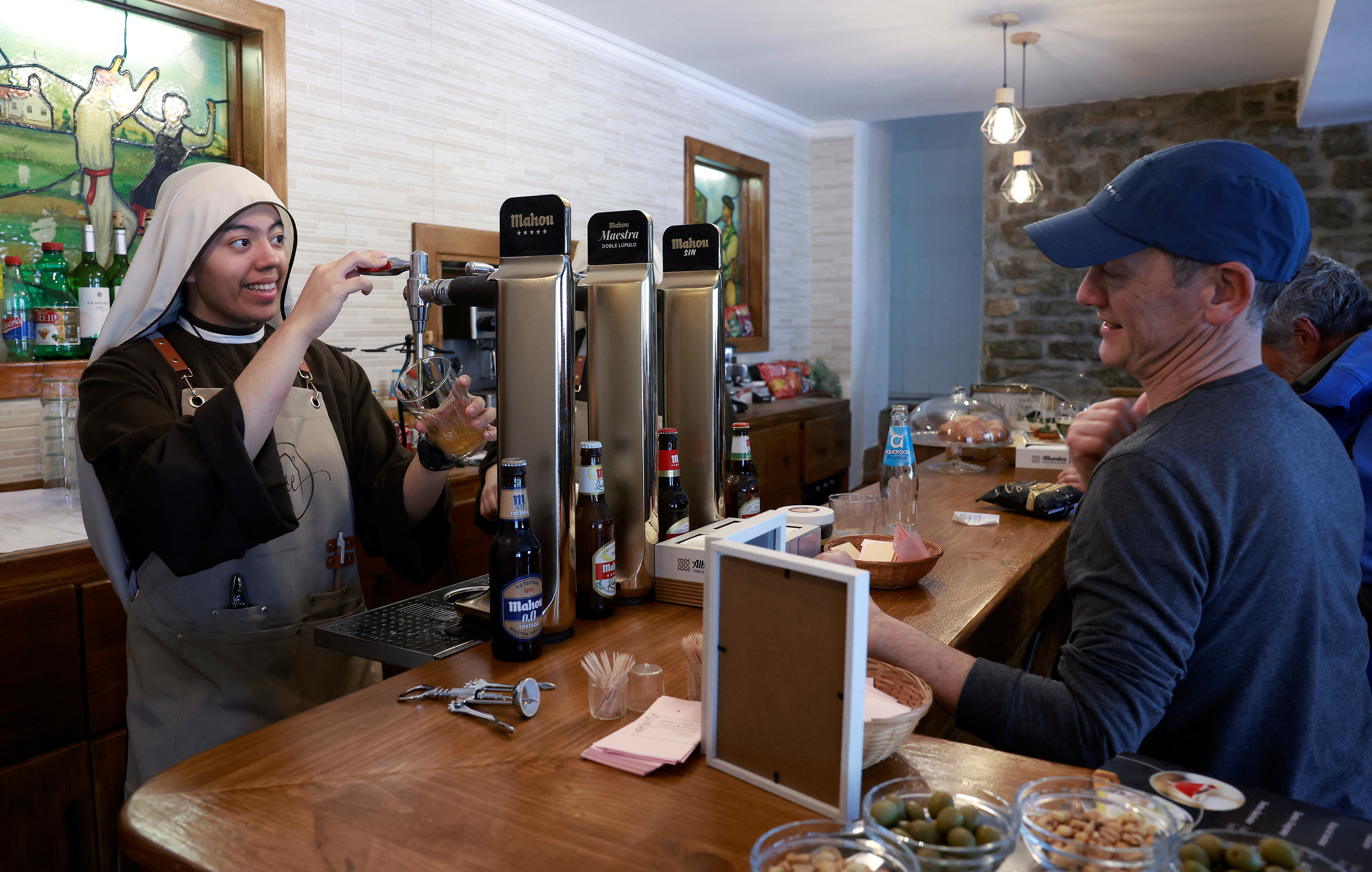 Nuns from the Hermanas Peregrinas de la Eucaristia order serve drinks at the Amaren Etxea (Mother's House) bar