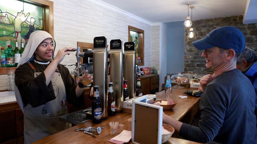 Nuns from the Hermanas Peregrinas de la Eucaristia order serve drinks at the Amaren Etxea (Mother's House) bar