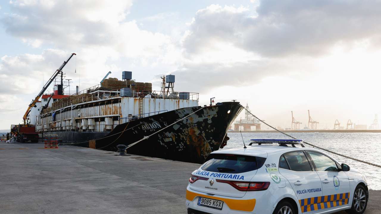 Police officers discharge drugs from the cattle ship Orion V seized off the Canary Islands, in the port of Las Palmas