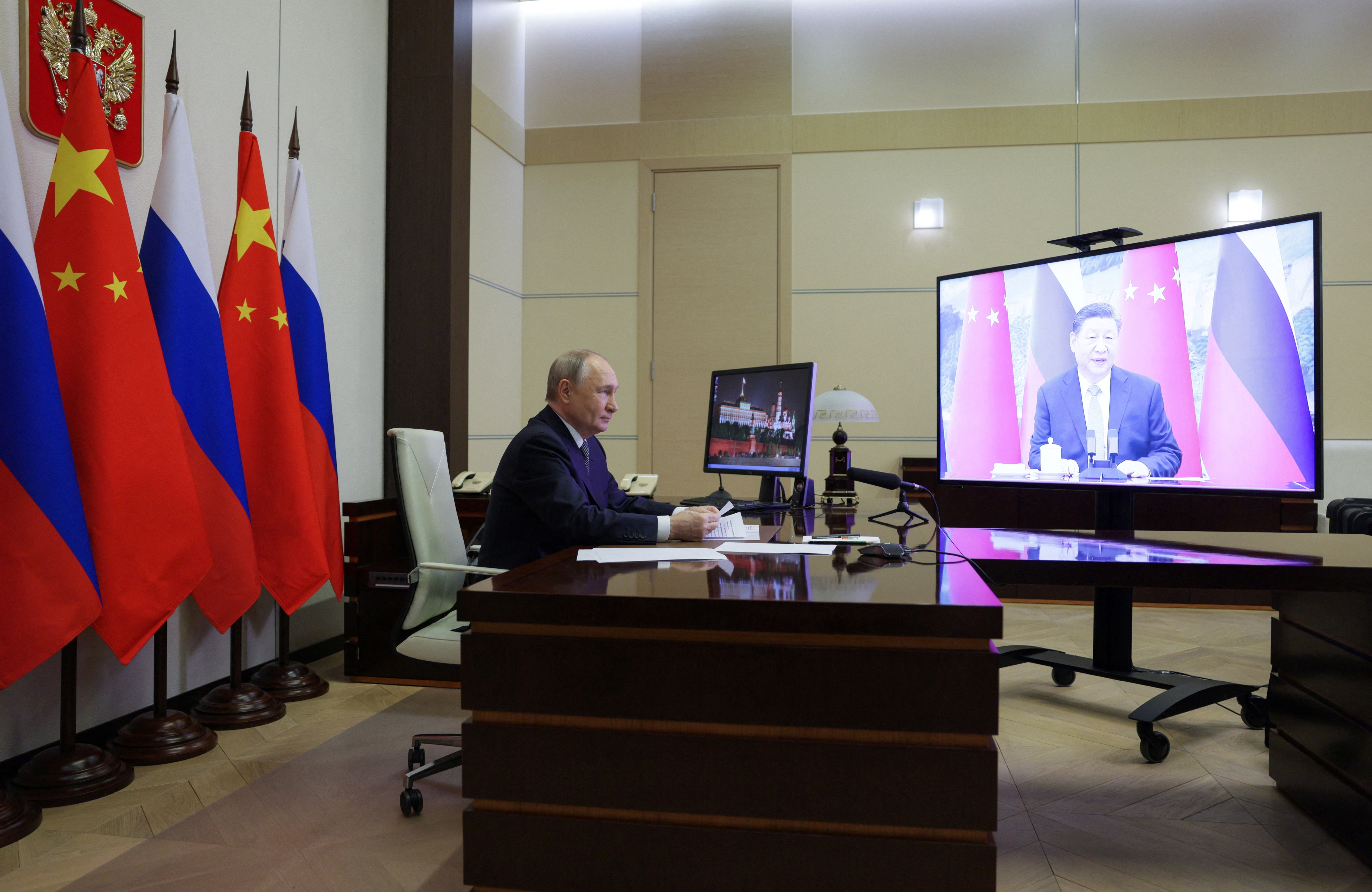 Russian President Vladimir Putin holds a video conference meeting with Chinese President Xi Jinping, outside Moscow