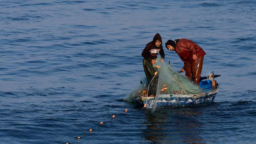 Palestinian fishermen work in Rafah