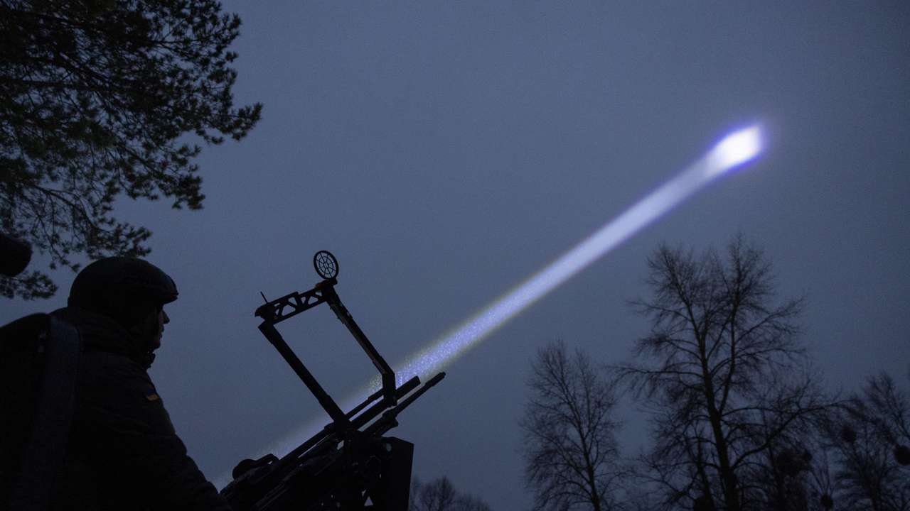Judge and spokesperson of Bila Tserkva district court Vladyslav Tsukurov observes the sky during a combat shift of his air defence volunteer unit in Kyiv region