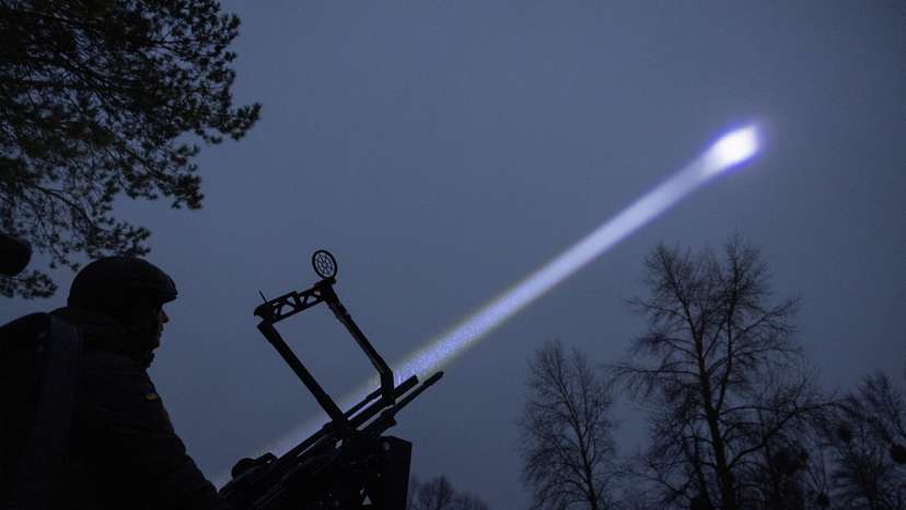 Judge and spokesperson of Bila Tserkva district court Vladyslav Tsukurov observes the sky during a combat shift of his air defence volunteer unit in Kyiv region