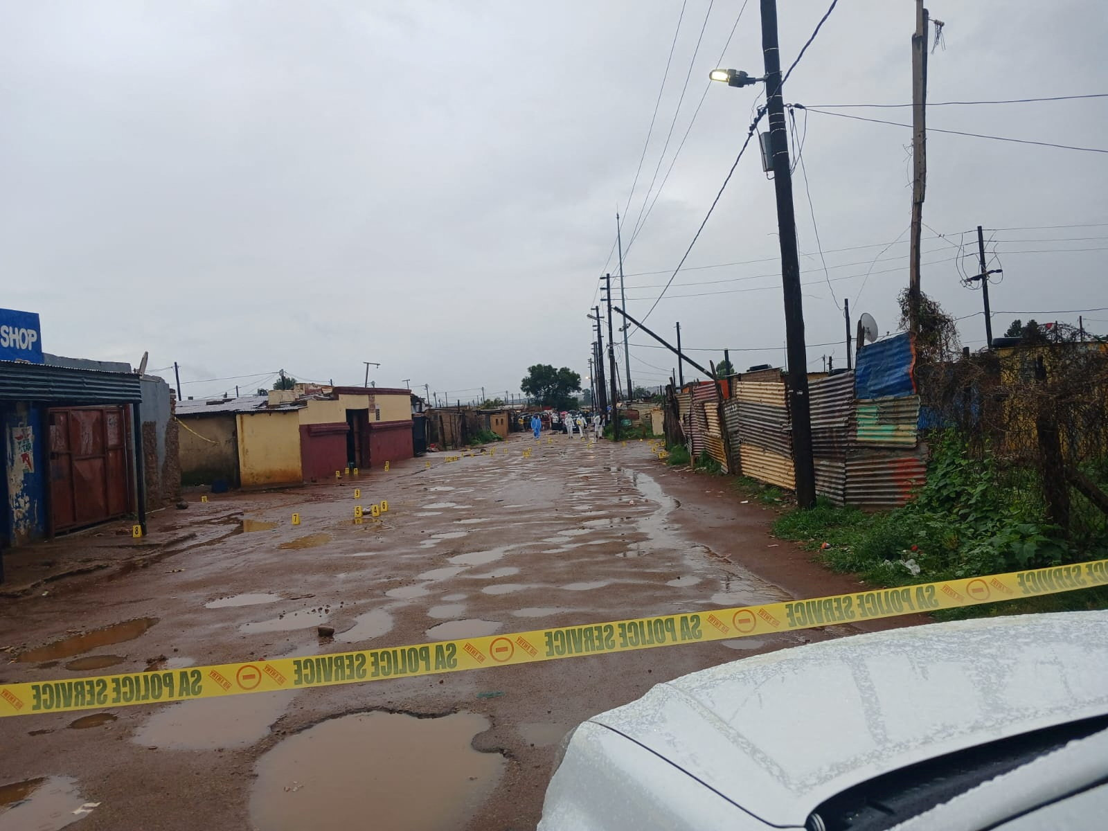 Photo marker cones are placed across the scene after an early morning shooting in Bekkersdal township south-west of Johannesburg