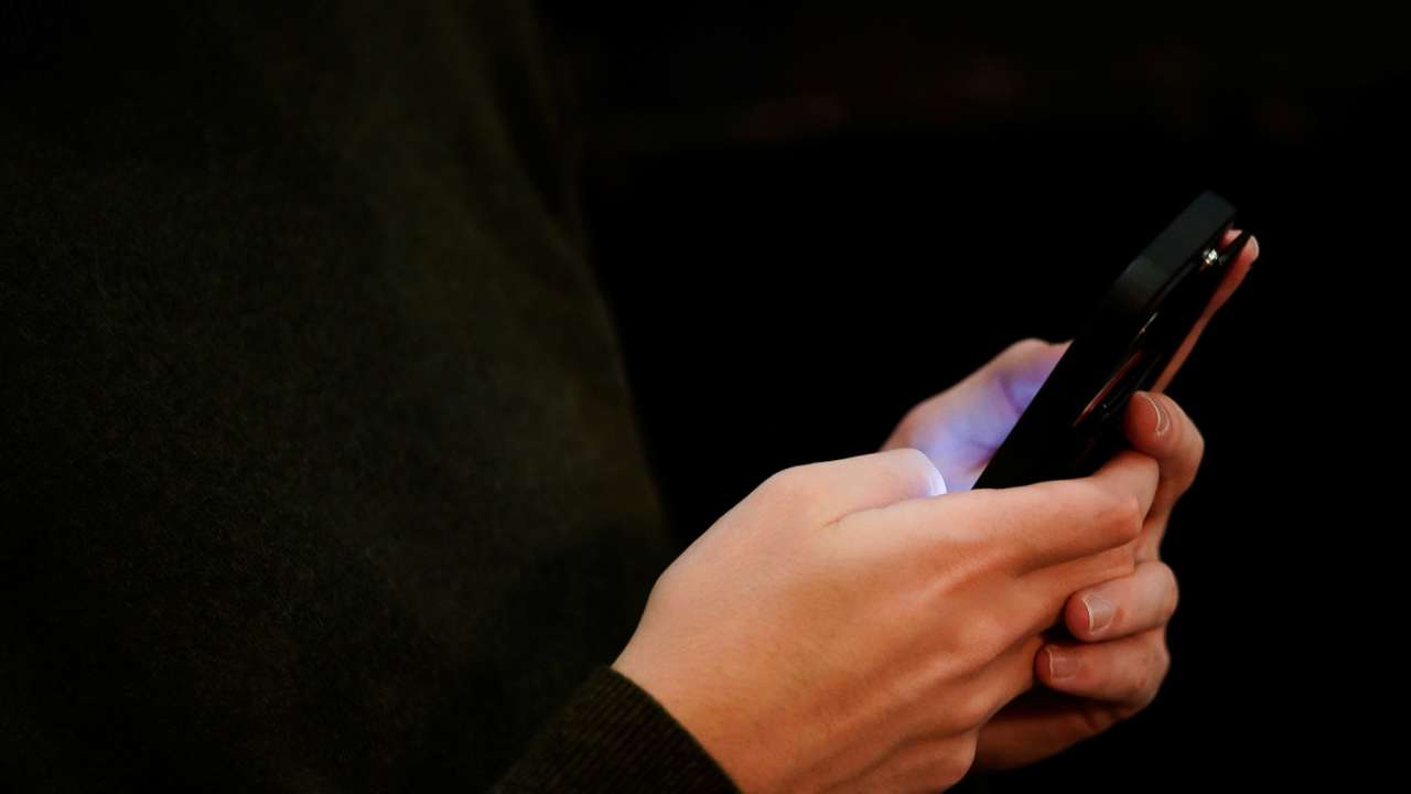 Josh Joffe, a 23-year-old Jewish American, sits with the phone he uses to access social media in Washington