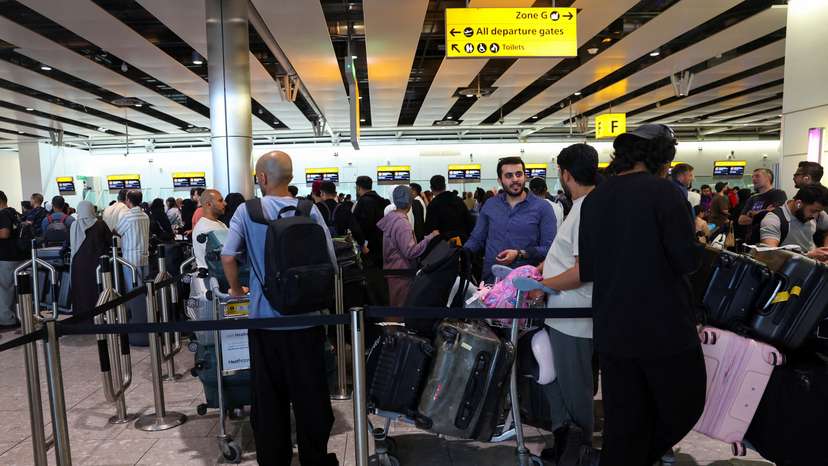 FILE PHOTO: Travellers at Heathrow Airport amid cyberattack disruptions, in Greater London