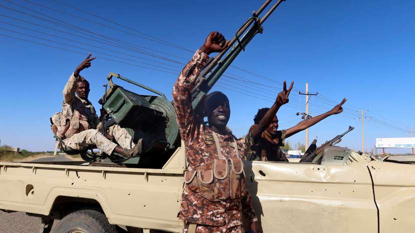 Sudan's army soldiers celebrate after entering Wad Madani