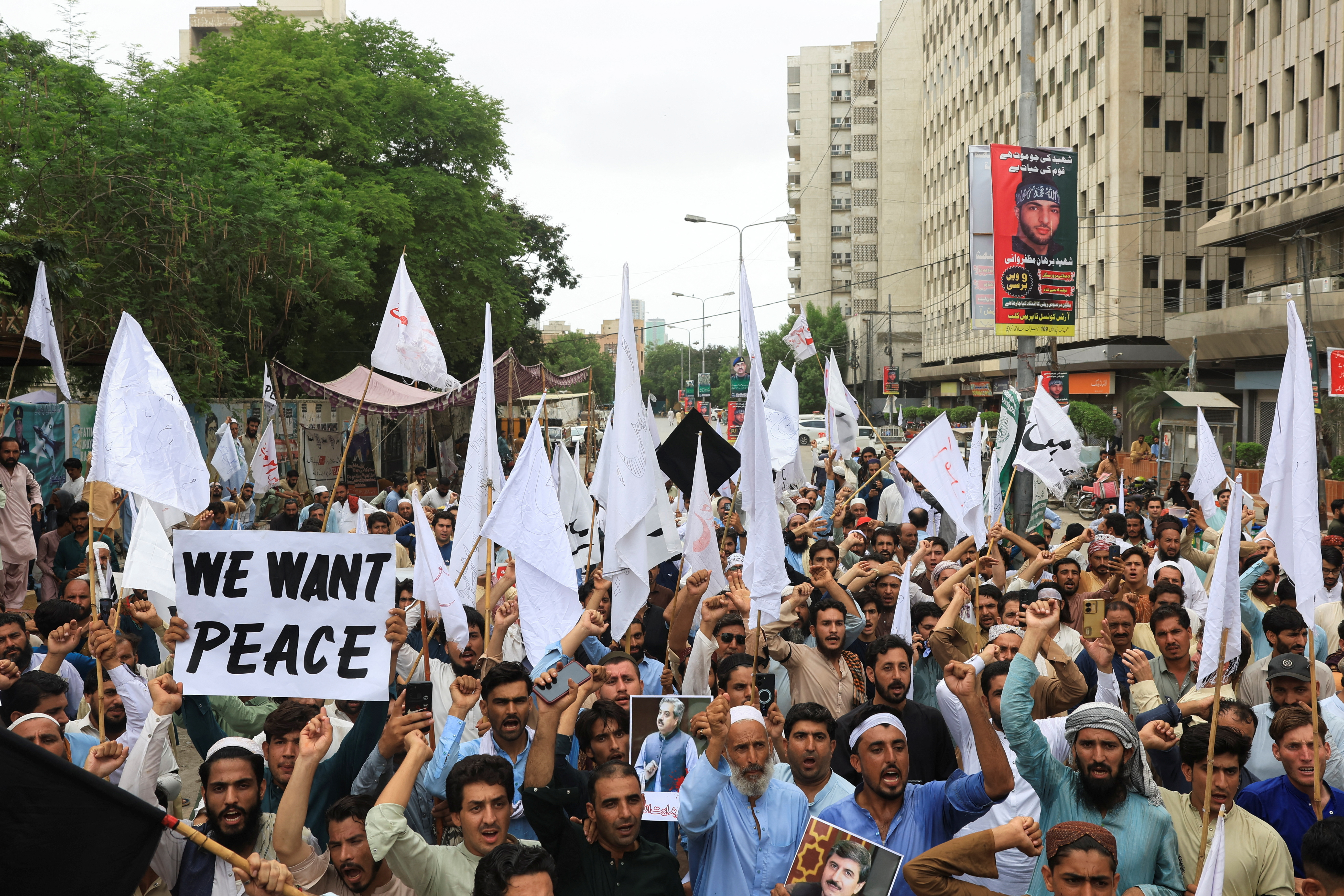 People rally to protest against the militant violence and demanding to restore peace during a protest in Karachi
