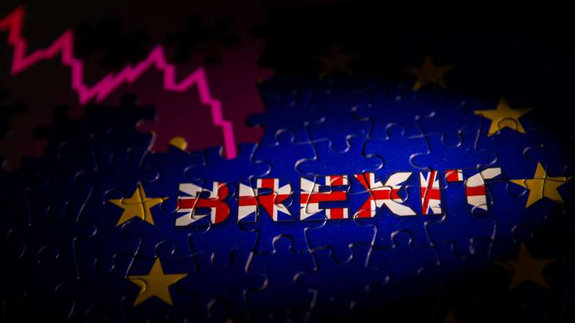 Puzzle with printed EU flag and BREXIT words is placed on displayed stock graph in this illustration taken