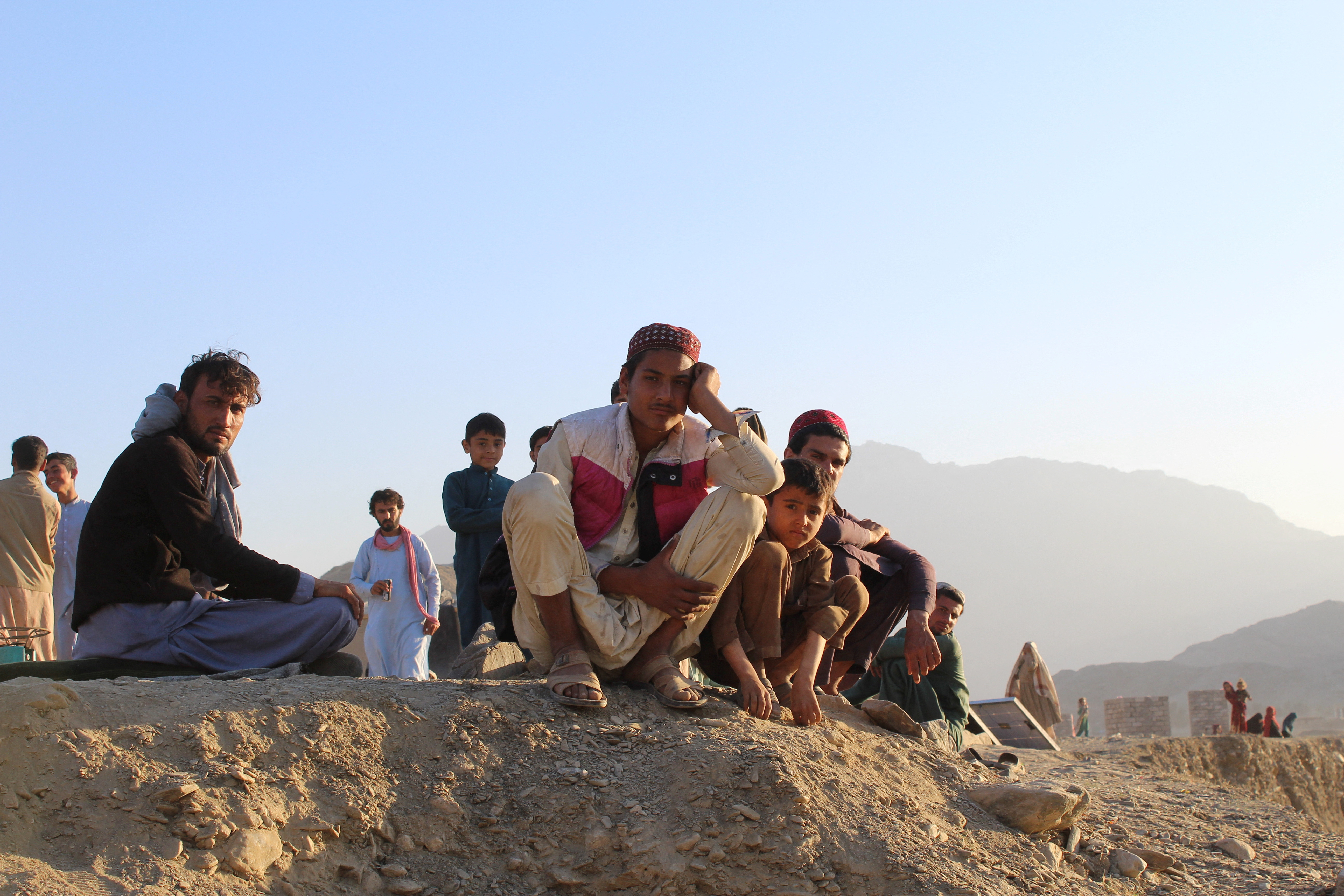 Afghan nationals rest at a camp after returning from Pakistan at Torkham border crossing