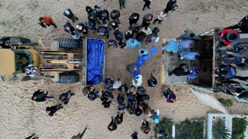 Palestinians killed in Israeli strikes and fire are buried in a mass grave in Rafah