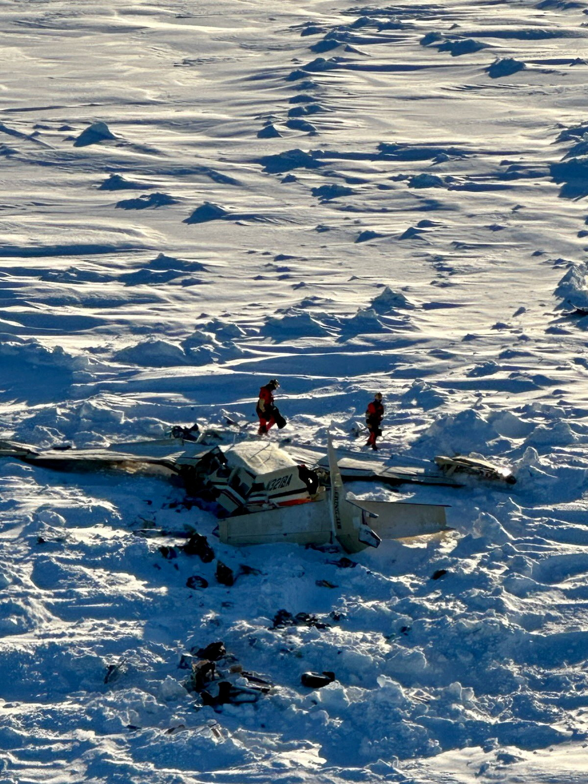 Authorities inspect the wreckage of the Cessna 208B Grand Caravan aircraft operated by Bering Air, near Nome