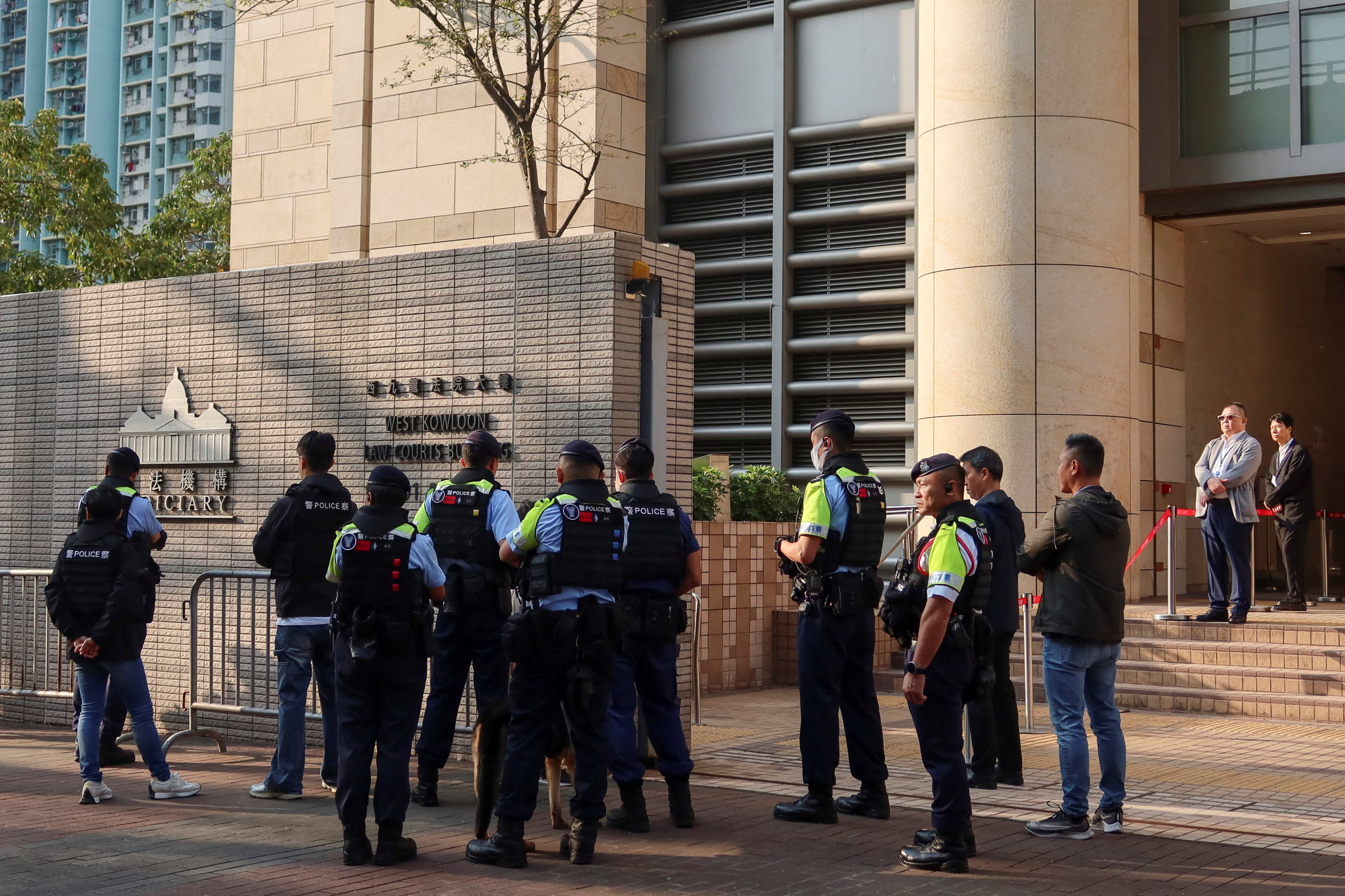 Police stand guard as twelve pro-democracy activists appeal their convictions and sentences in a landmark national security case at the West Kowloon Magistrates' Courts building, in Hong Kong