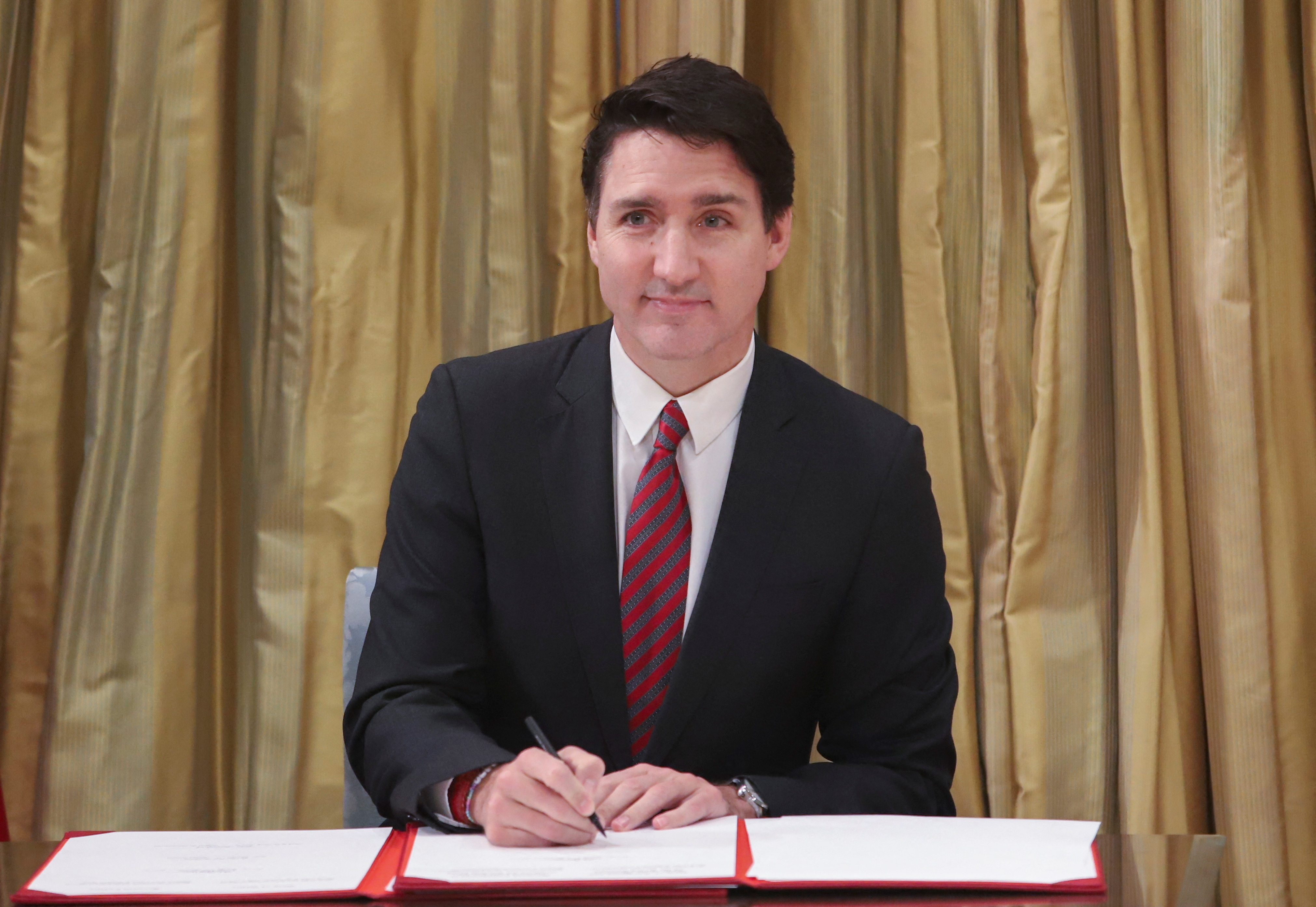 Canada's PM Trudeau signs a register as he takes part in swearing-in ceremony at Rideau Hall in Ottawa