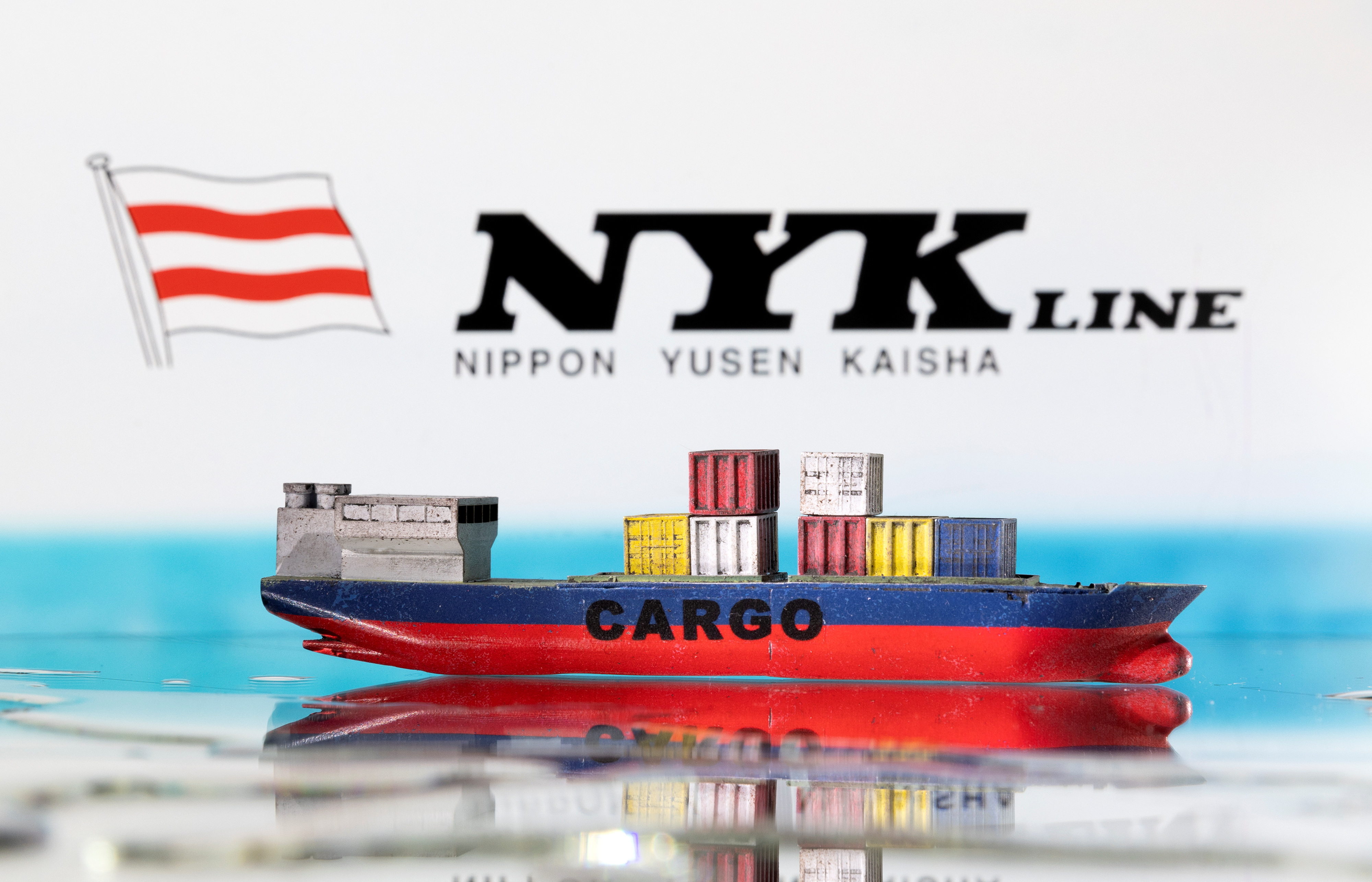 Illustration shows cargo boat model and Nippon Yusen (NYK) logo