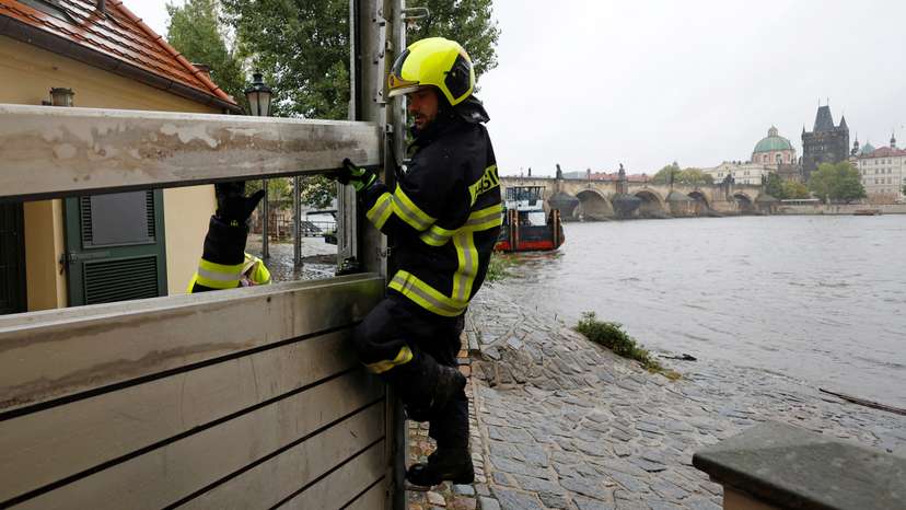 Firefighters assemble a water barrier in Prague