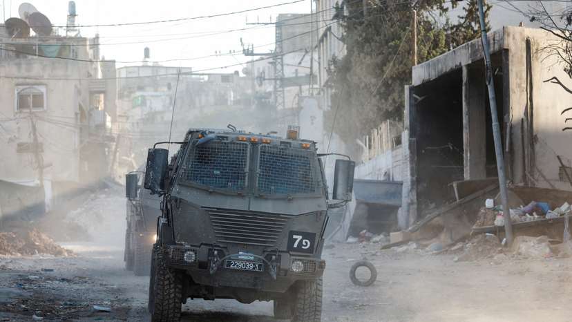 Israeli military vehicles operate during an Israeli raid in Tulkarm
