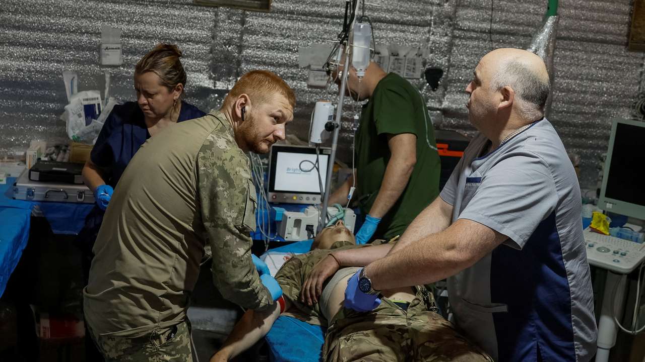 Medics help a wounded Ukrainian serviceman inside a medical stabilisation point near the town of Chasiv Yar, in Donetsk region
