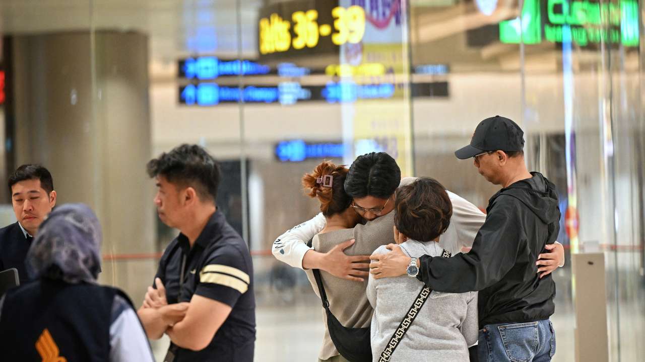 Passengers who were on board the flight SQ321 from London arrive at Changi Airport, in Singapore