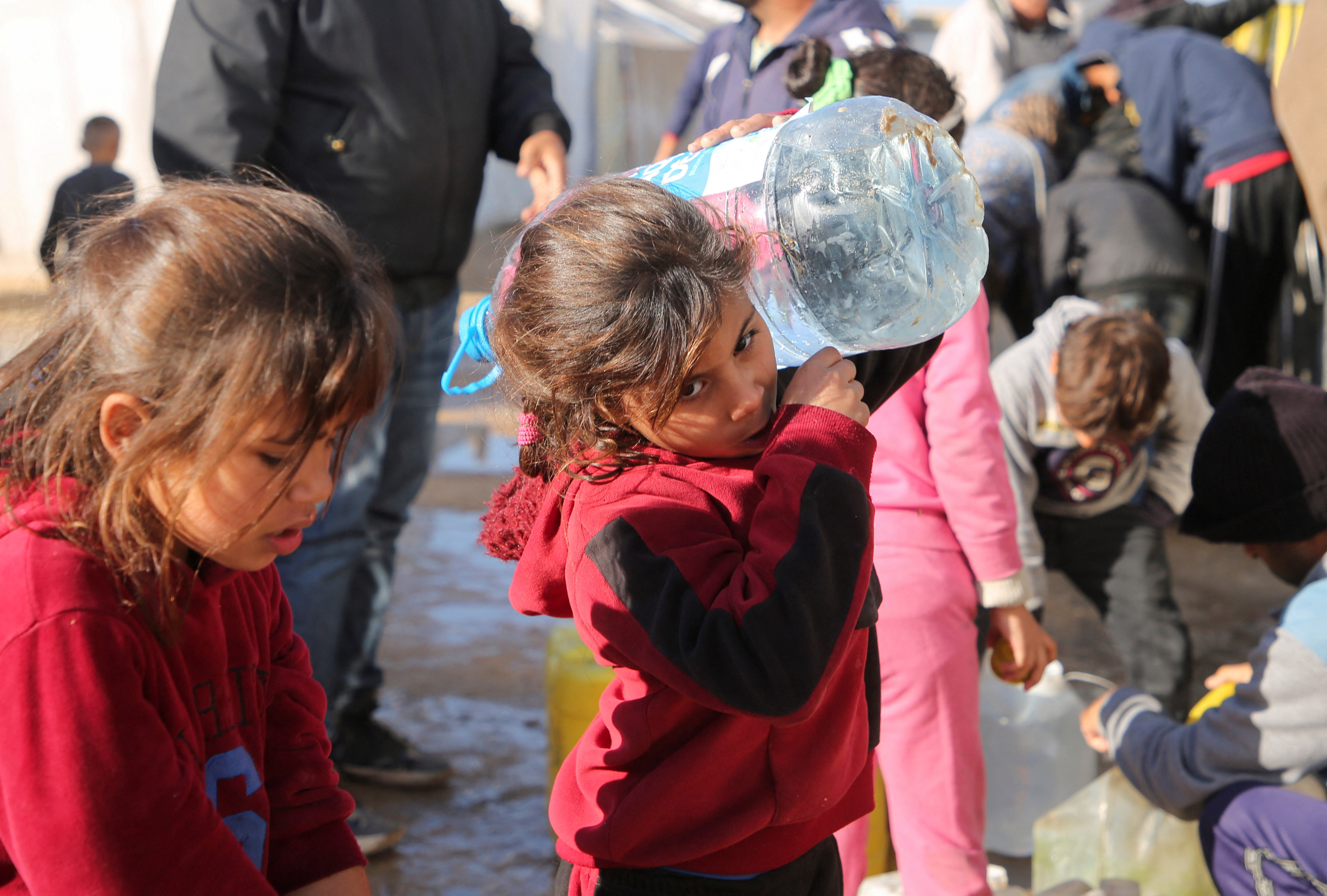 Palestinians wait to collect water in Khan Younis
