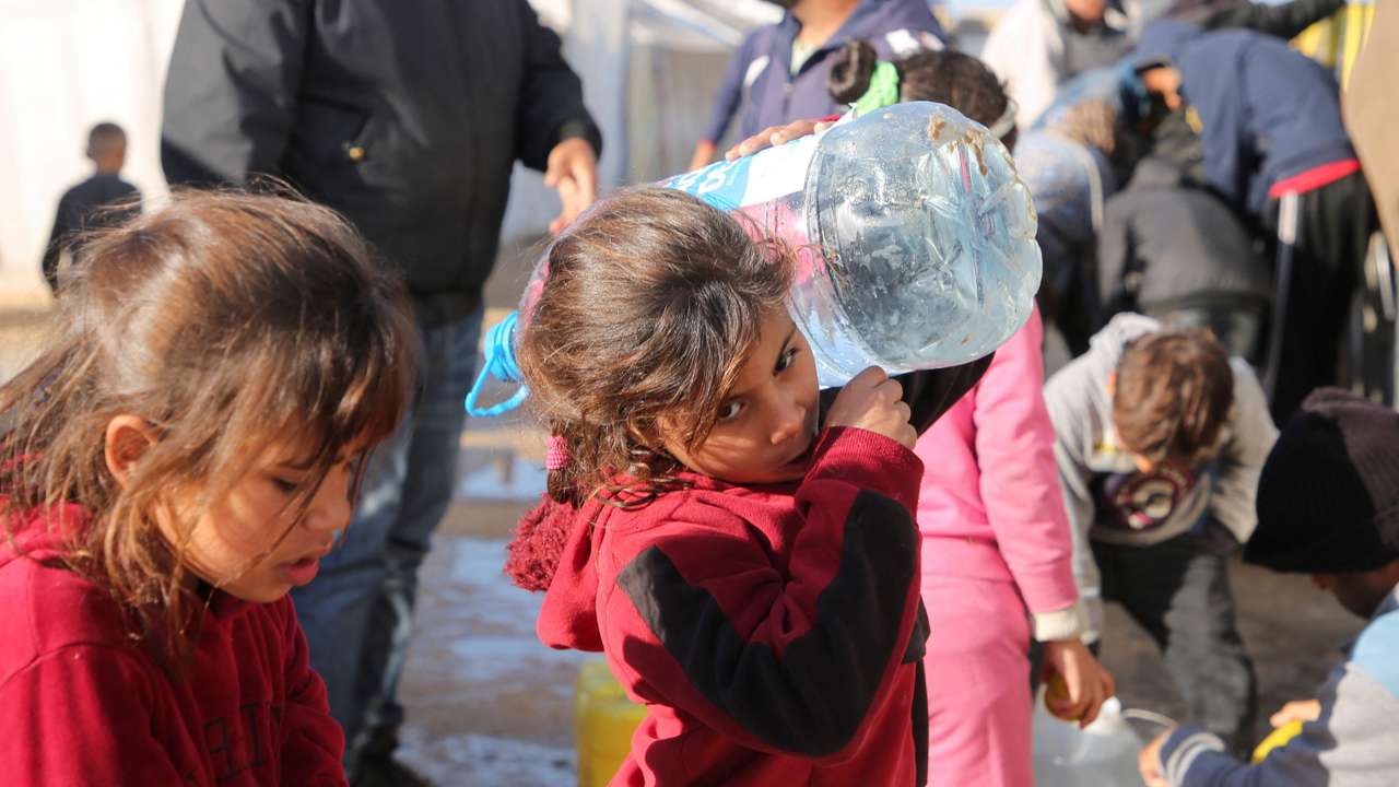 Palestinians wait to collect water in Khan Younis
