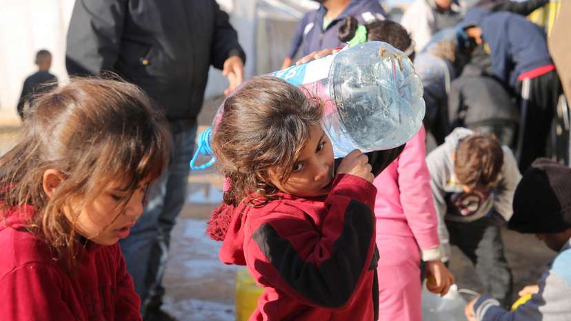 Palestinians wait to collect water in Khan Younis