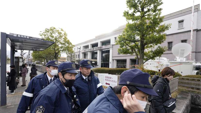 Police officers gather outside the Kyoto District Court ahead of the sentencing hearing for Shinji Aoba, who has confessed to a deadly arson attack in July 2019 on a Kyoto Animation Co. studio in Kyoto