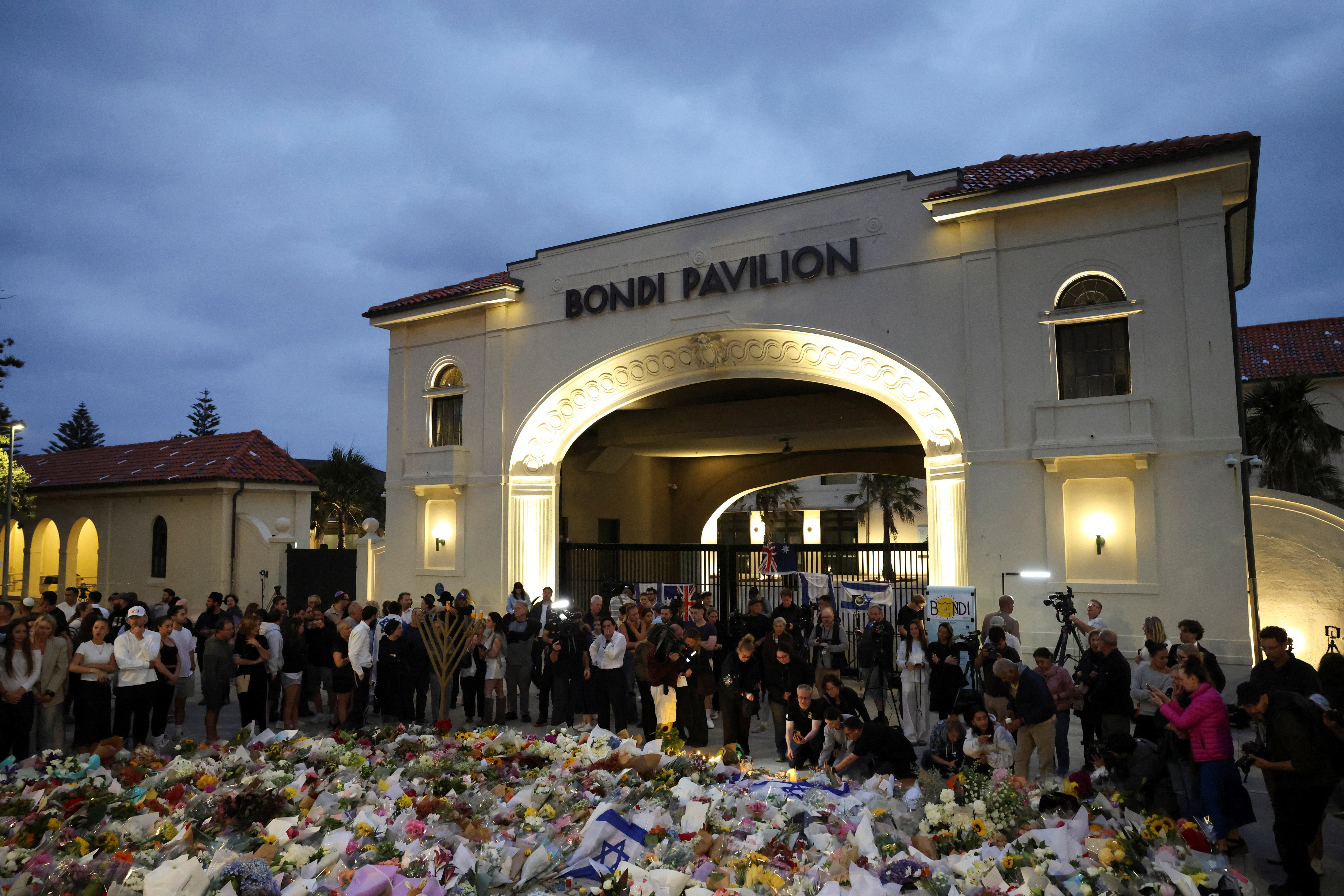 People pay respects at Bondi Pavilion to victims of a shooting during a Jewish holiday celebration at Bondi Beach, in Sydney