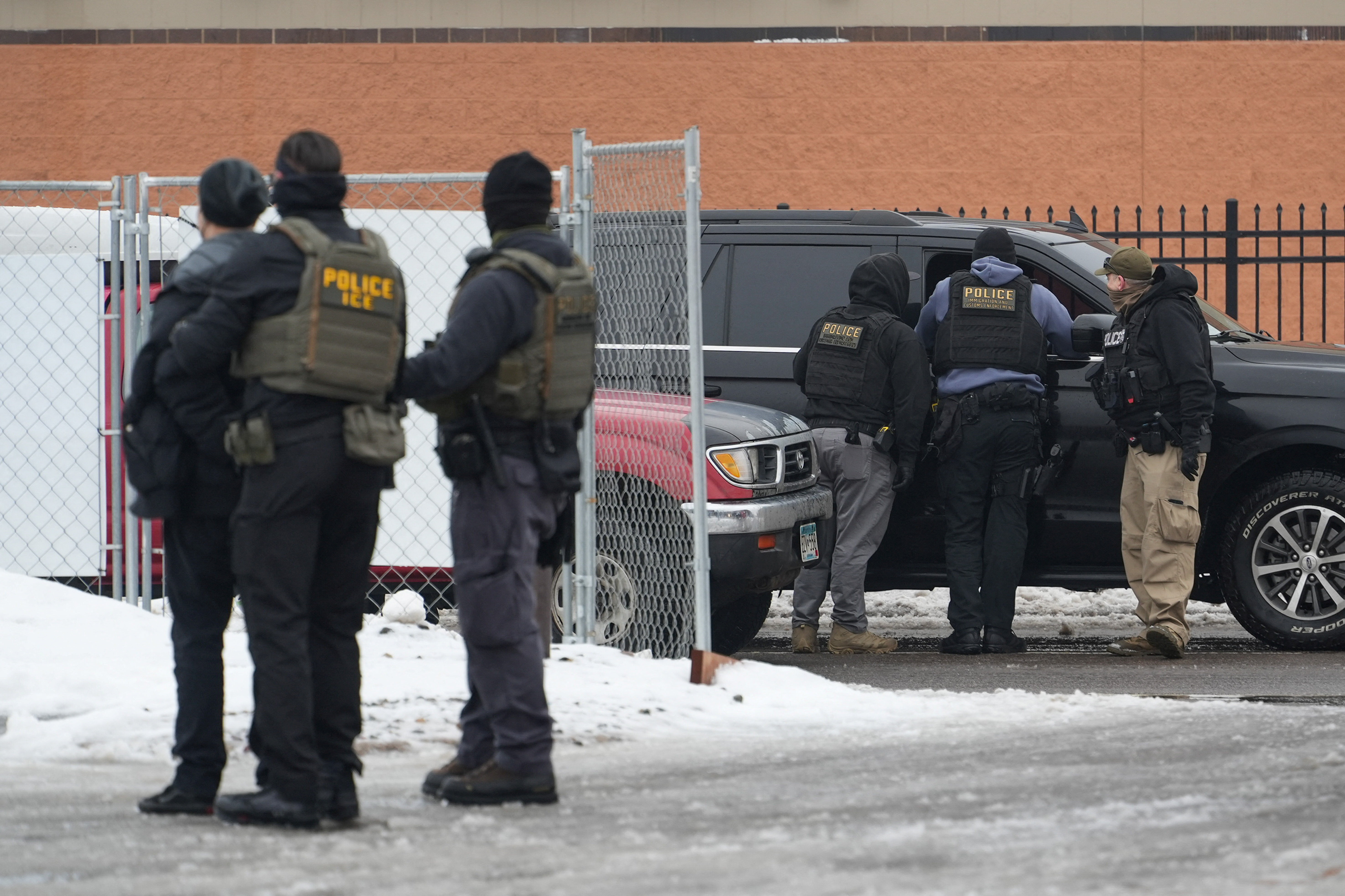 Members of U.S. Immigration and Customs Enforcement (ICE) conduct raids in Minneapolis