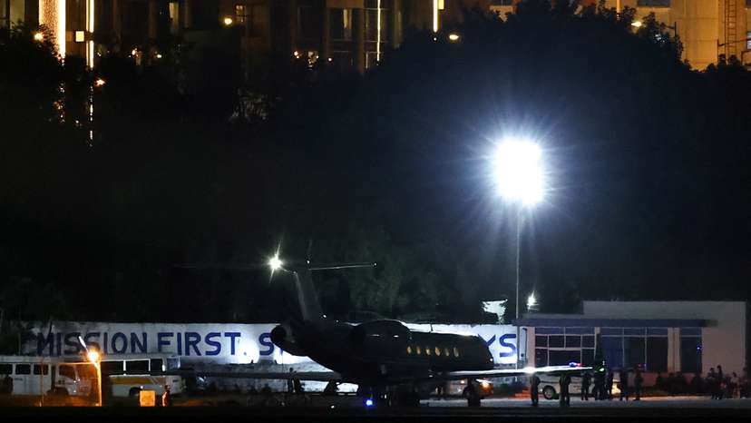 Former Philippine President Duterte boards a plane at Villamor Airbase after being arrested