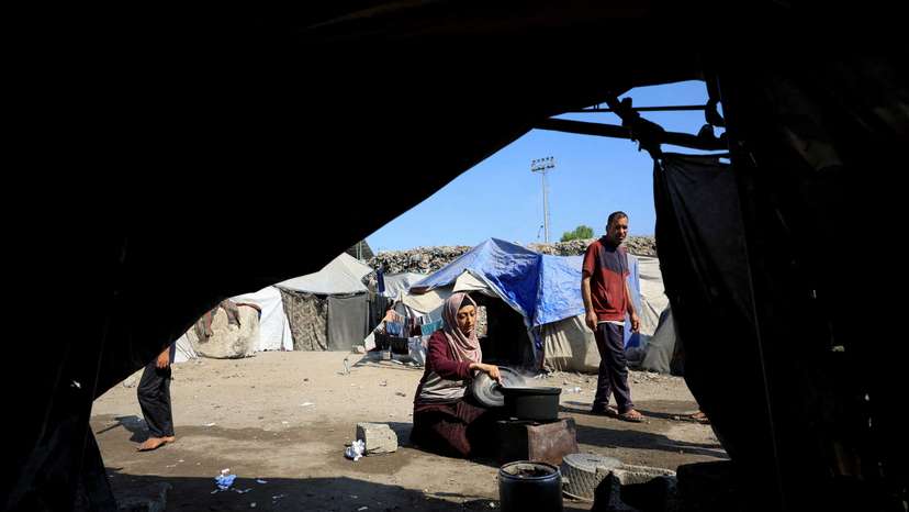 Displaced Palestinians who have not received humanitarian aid survive on leftover food, in Gaza