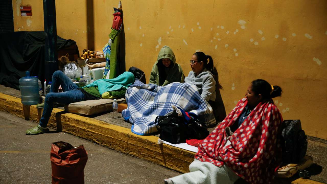 Family members of detainees wait outside the National Police Zone 7 Detention Centre, in Caracas