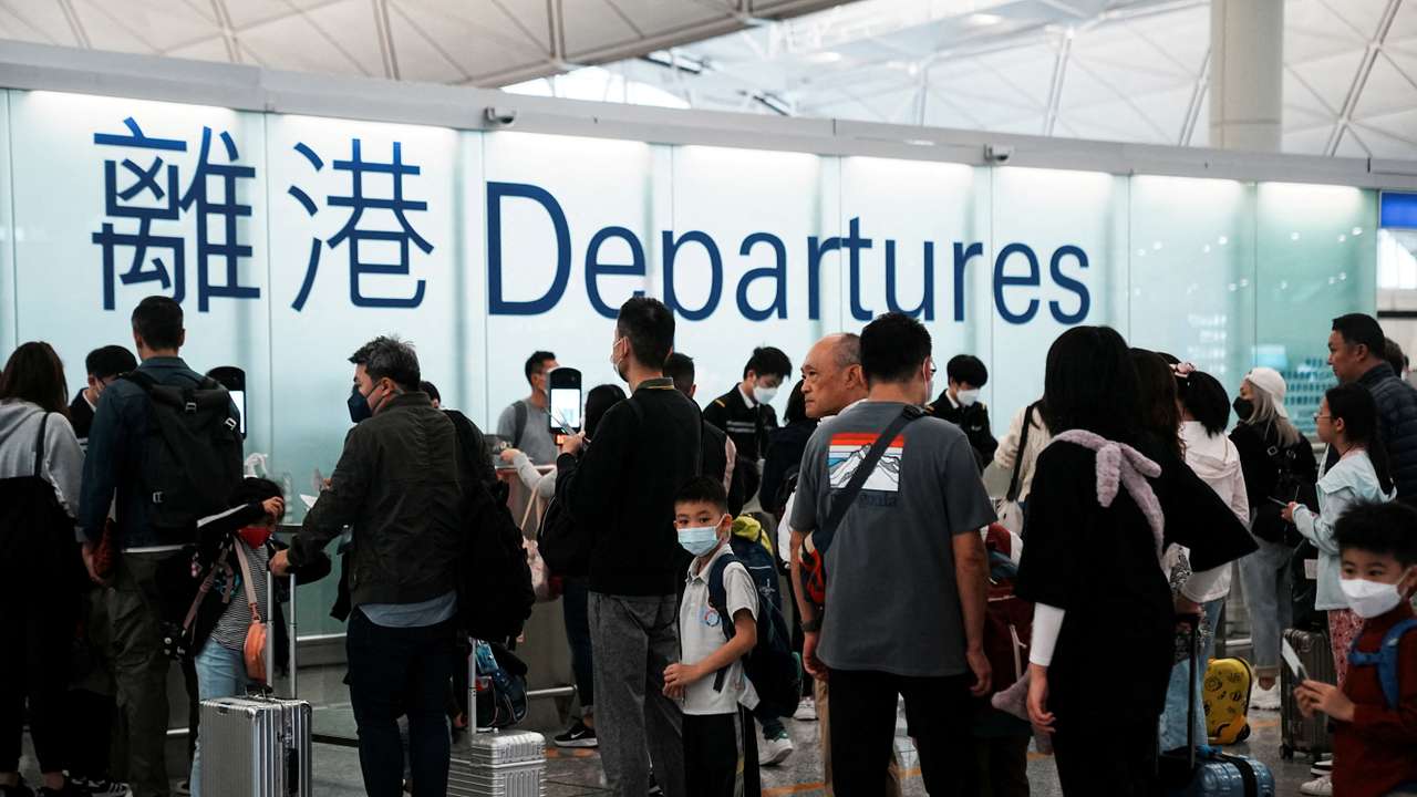 FILE PHOTO: Travellers at Hong Kong International Airport