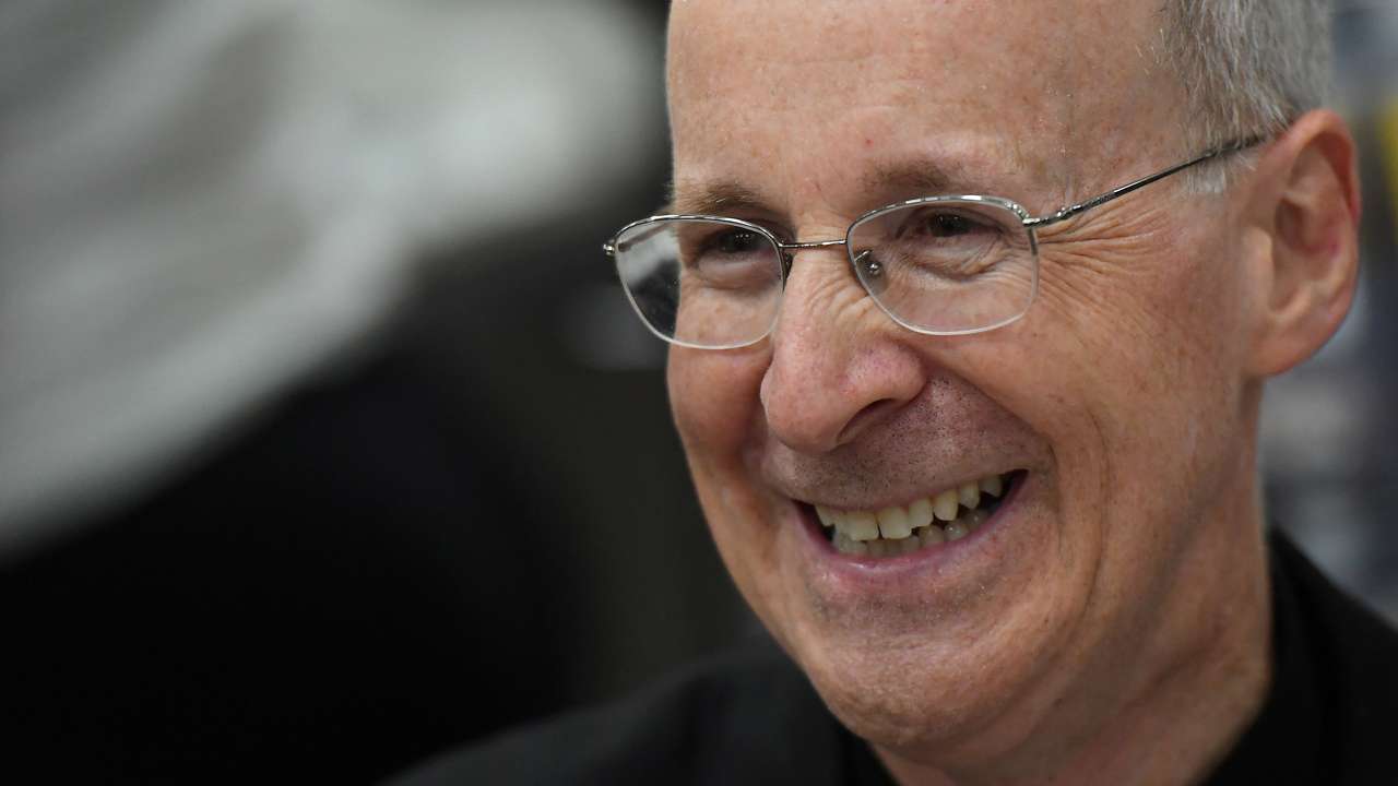 FILE PHOTO: Jesuit priest father James Martin of the U.S. smiles as he signs copies of his book at the Pastoral Congress at the World Meeting of Families in Dublin, Ireland