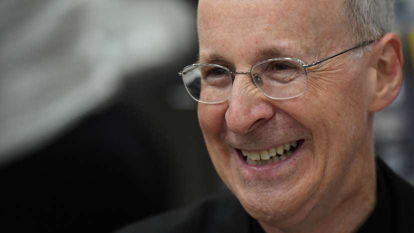 FILE PHOTO: Jesuit priest father James Martin of the U.S. smiles as he signs copies of his book at the Pastoral Congress at the World Meeting of Families in Dublin, Ireland