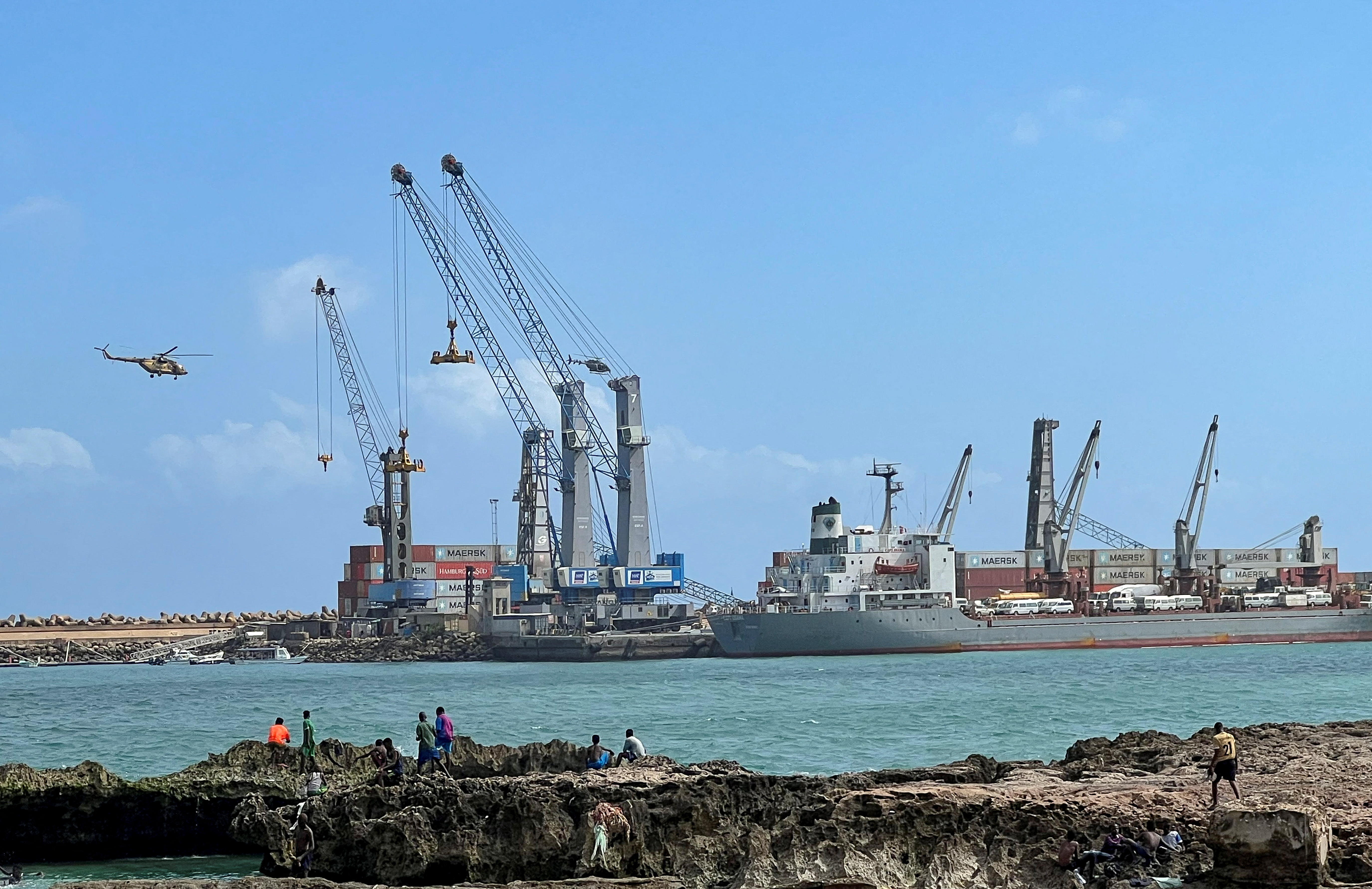 Security helicopters hover above the Mogadishu Sea Port after an Egyptian warship docked to deliver a second major cache of weaponry in Mogadishu