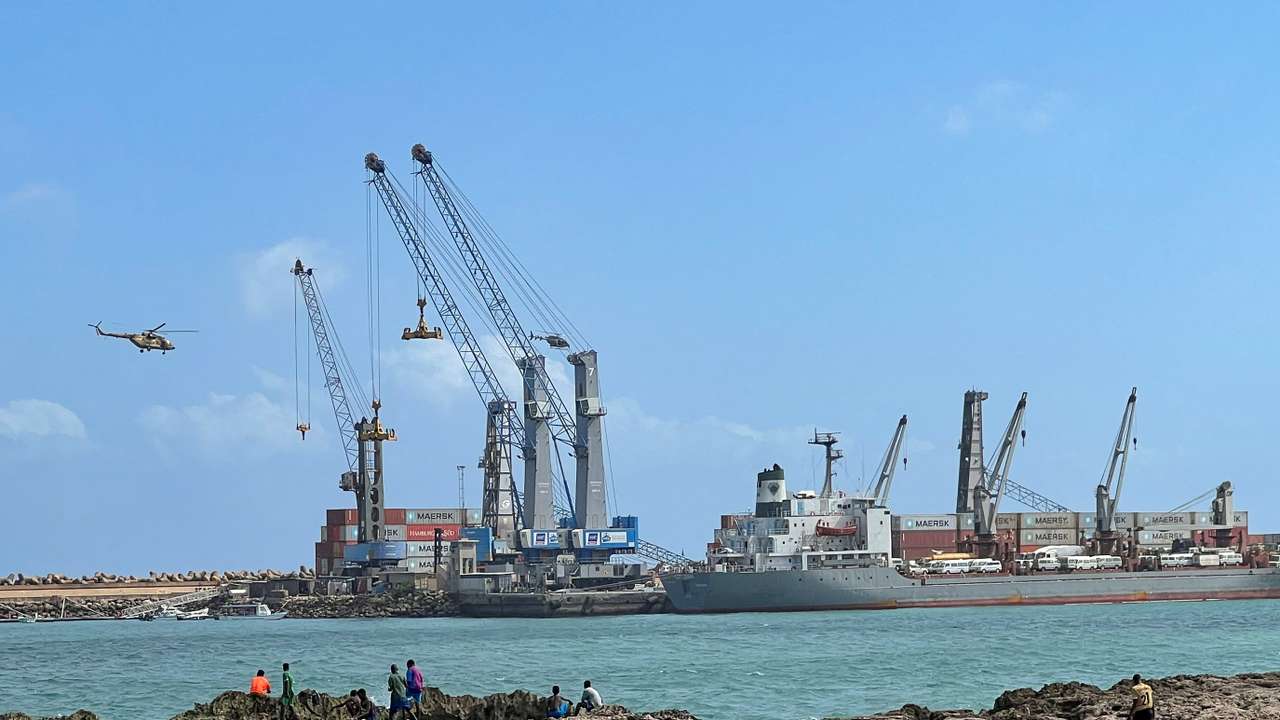 Security helicopters hover above the Mogadishu Sea Port after an Egyptian warship docked to deliver a second major cache of weaponry in Mogadishu