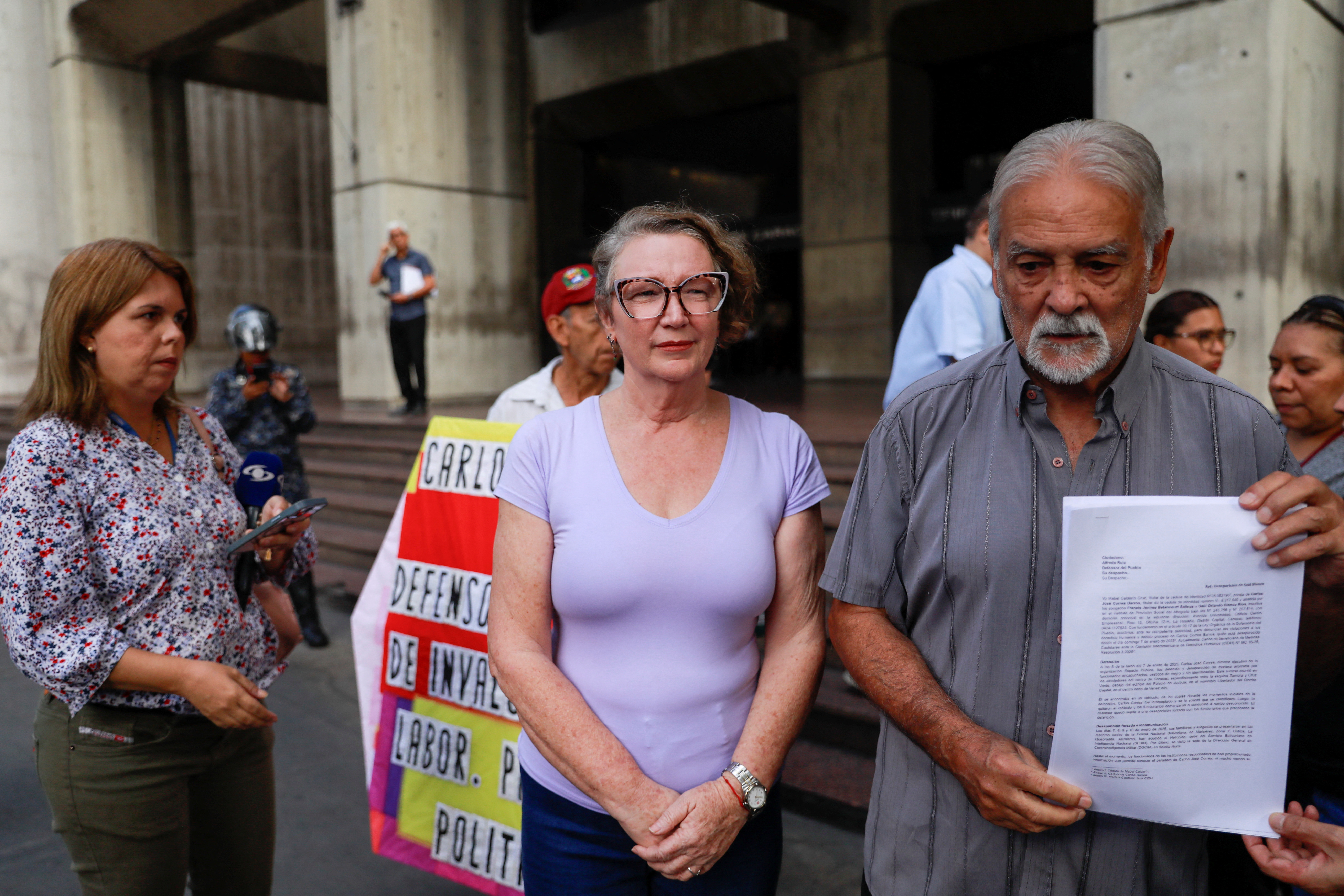 Mabel Calderin, the wife of Carlos Correa, director of press freedom NGO Espacio Publico, addresses the media, in Caracas