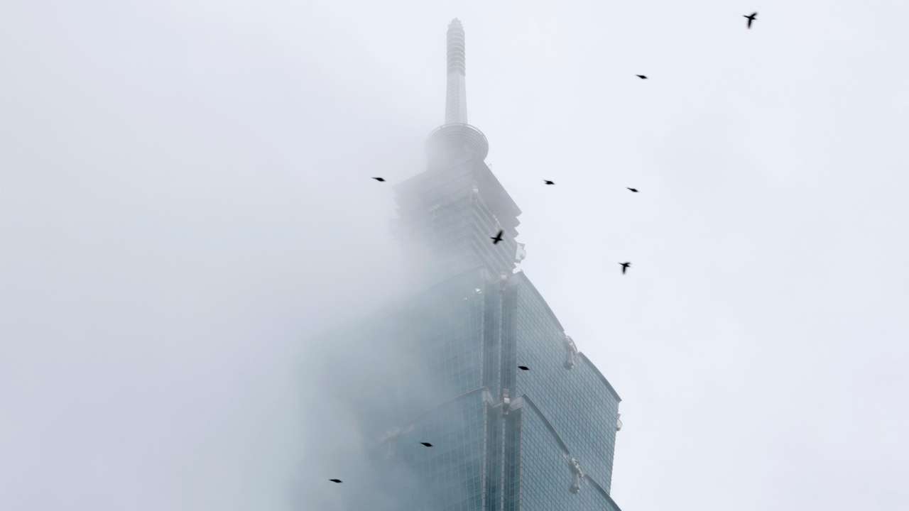 Climber Alex Honnold free soloing Taipei 101 Skyscraper
