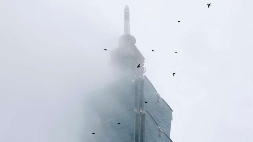 Climber Alex Honnold free soloing Taipei 101 Skyscraper