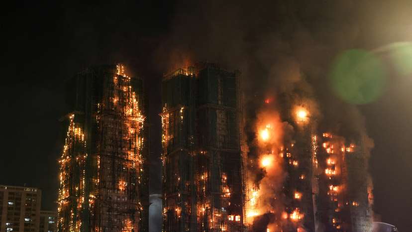 FILE PHOTO: Flames and thick smoke rise from the Wang Fuk Court housing complex during a deadly fire, in Hong Kong