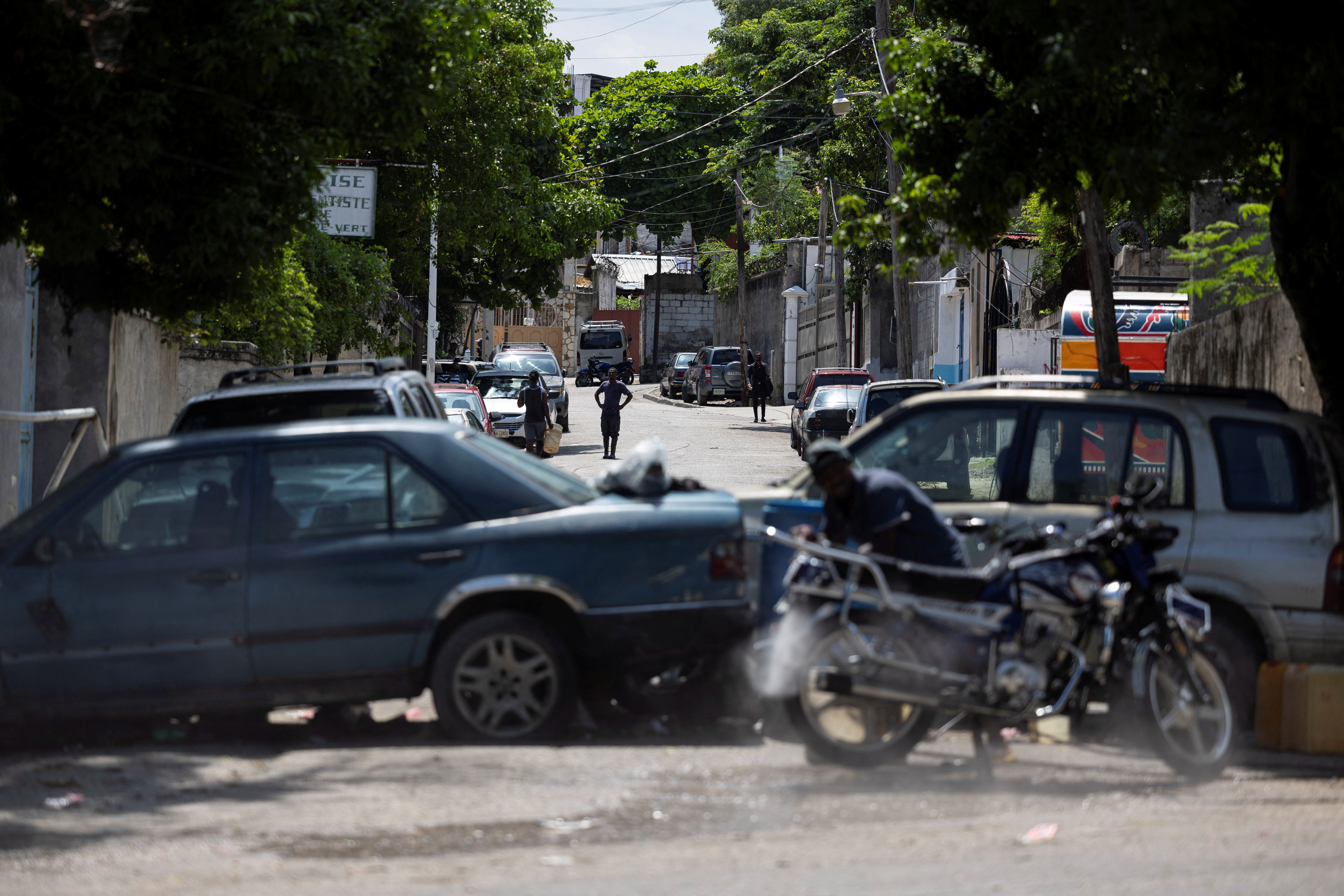 A view of a makeshift barricade built by residents out of abandoned vehicles to block a road and prevent gangs from entering their community, in Port-au-Prince