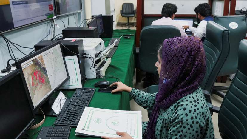 A worker monitors the smog situation on a computer screen at the Smog Cell at the Environment Protection and Climate Change Department in Lahore