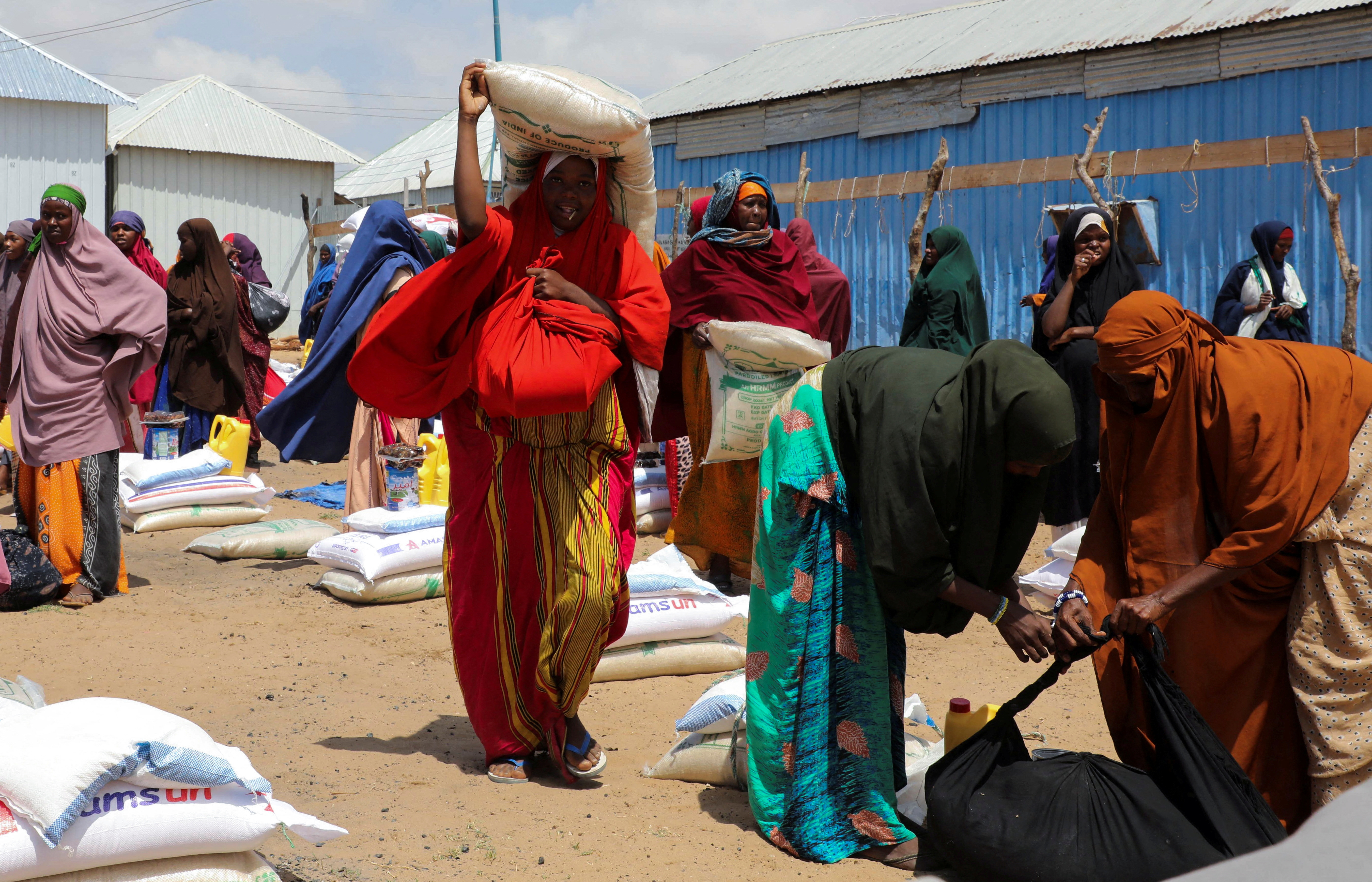 FILE PHOTO: Internally displaced Somalis receive dry relief food from Kuwait charity in Mogadishu