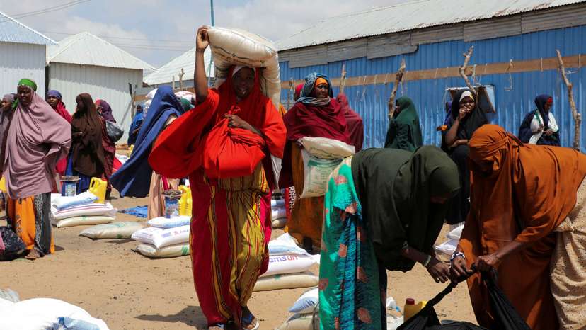FILE PHOTO: Internally displaced Somalis receive dry relief food from Kuwait charity in Mogadishu