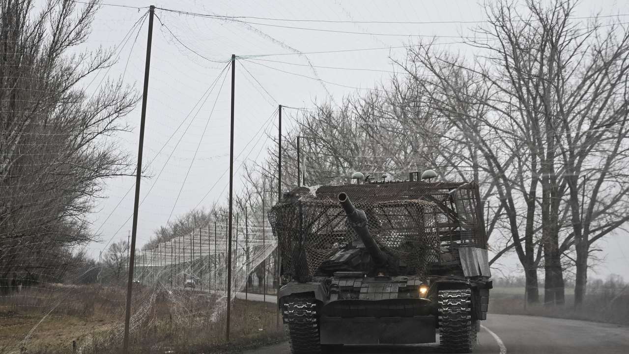 Ukrainian servicemen ride a tank near a front line near the town of Pokrovsk