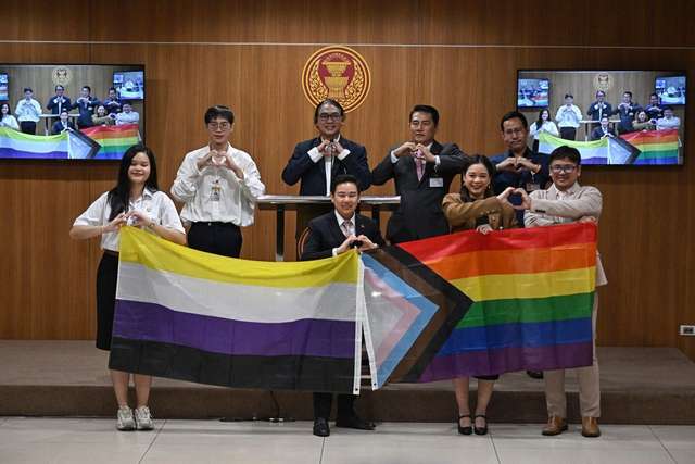 Members of Parliament (MPs) and parliamentary interns from the Move Forward Party (MFP) pose during a presser ahead of the final senatorial vote on the same-sex marriage bill at the Thai Parliament in Bangkok on June 18, 2024.