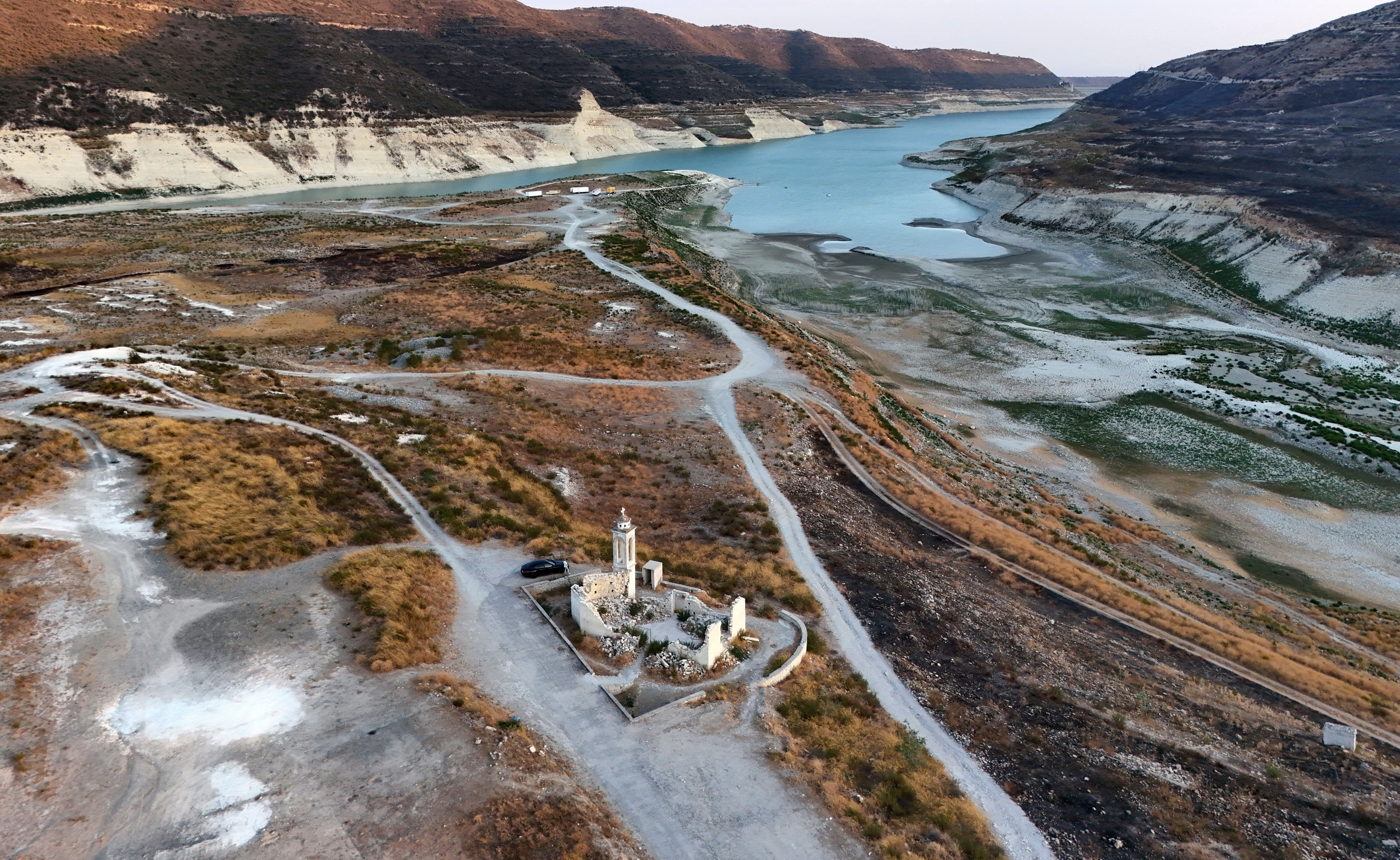 Aerial view of Kouris reservoir, where a once-submerged Church is fully exposed near Alassa village in Limassol