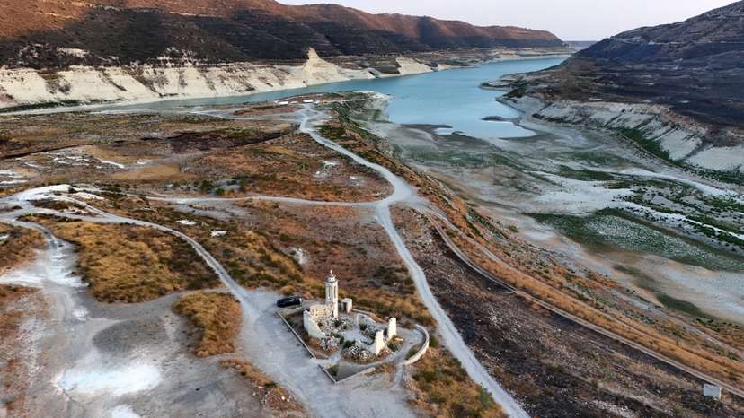 Aerial view of Kouris reservoir, where a once-submerged Church is fully exposed near Alassa village in Limassol