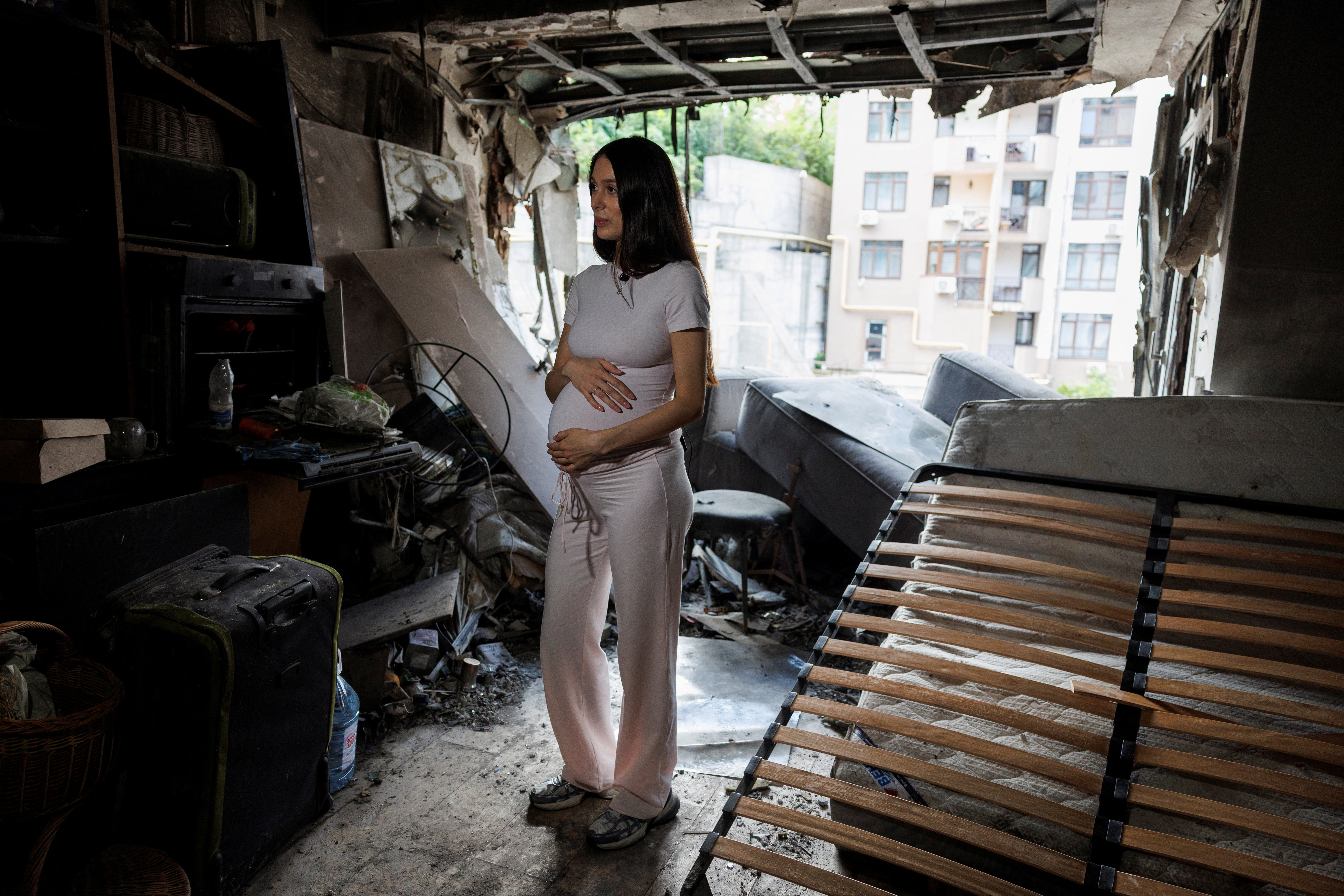 Bohdana Zhupanyna stands inside of her apartment damaged by a Russian drone strike in Kyiv